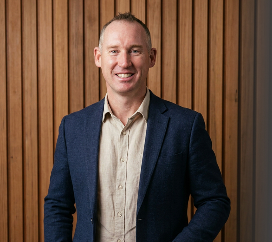 Sentinel Homes founder at the door of an award-winning home